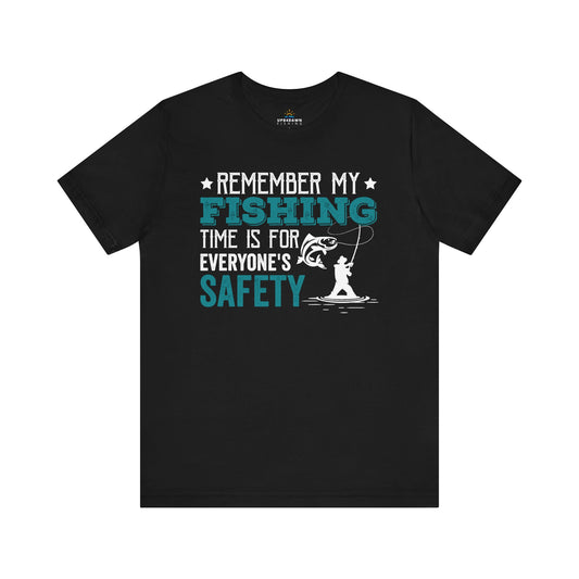 Black t-shirt with a fish-themed design featuring the Remember, My Fishing Time is for Everyone's Safety - T-Shirt in white and turquoise, showcasing an illustration of a man fishing.