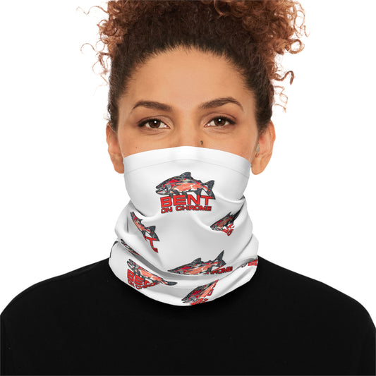 A woman with curly hair wearing a Bent On Chrome lightweight neck gaiter with red salmon logo, over her nose and mouth, looking directly at the camera. This moisture-wicking polyester neck gaiter.