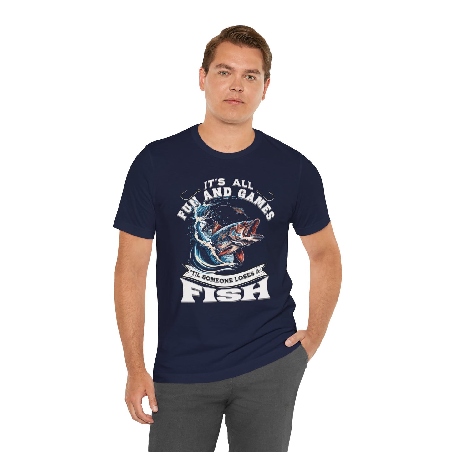 Navy blue unisex It's All Fun and Games Until Someone Loses a Fish - T-shirt featuring a graphic of a leaping fish with its mouth open, encircled by the phrase "it's all fun and games 'til someone loses a fish.