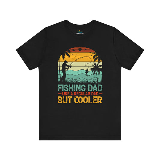 Sentence with replaced product name: Black casual unisex tee with a graphic of a man fishing on a beach at sunset, surrounded by palm trees, and the text "Fishing Dad Like a Regular Dad but Cooler" in.