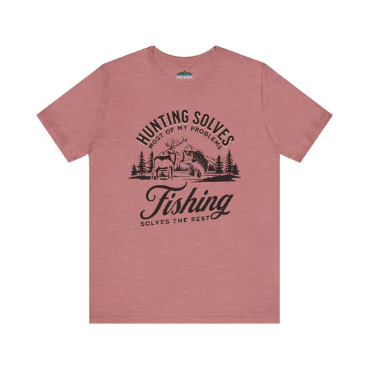 A pink Hunting Solves Most of My Problems, Fishing Solves the Rest - T-Shirt featuring a graphic with the text "hunting solves most of my problems, fishing solves the rest" and an illustration of a cabin in the woods with a deer and fishing elements.