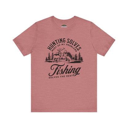 A pink Hunting Solves Most of My Problems, Fishing Solves the Rest - T-Shirt featuring a graphic with the text "hunting solves most of my problems, fishing solves the rest" and an illustration of a cabin in the woods with a deer and fishing elements.