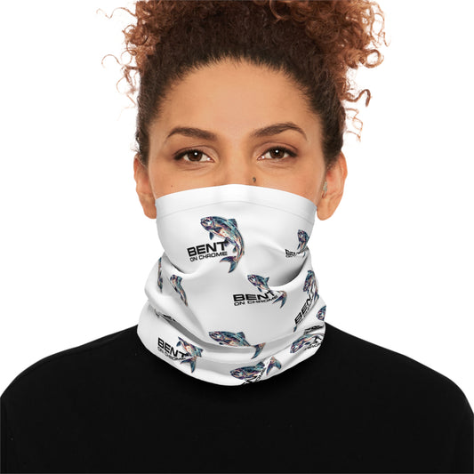 A woman with curly hair wearing a "Bent On Chrome - Lightweight Neck Gaiter" face mask with colorful abstract patterns, set against a neutral background. The mask covers her mouth and nose, branded with the "benti" logo.