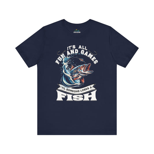 Navy blue unisex It's All Fun and Games Until Someone Loses a Fish - T-shirt featuring a graphic of a leaping fish with its mouth open, encircled by the phrase "it's all fun and games 'til someone loses a fish.