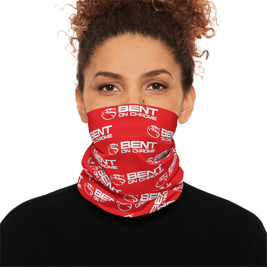 A woman wearing a black top and a red Bent On Chrome - Lightweight Neck Gaiter with the text "bent on chrome" printed in white. Her hair is styled in a curly updo, and she is