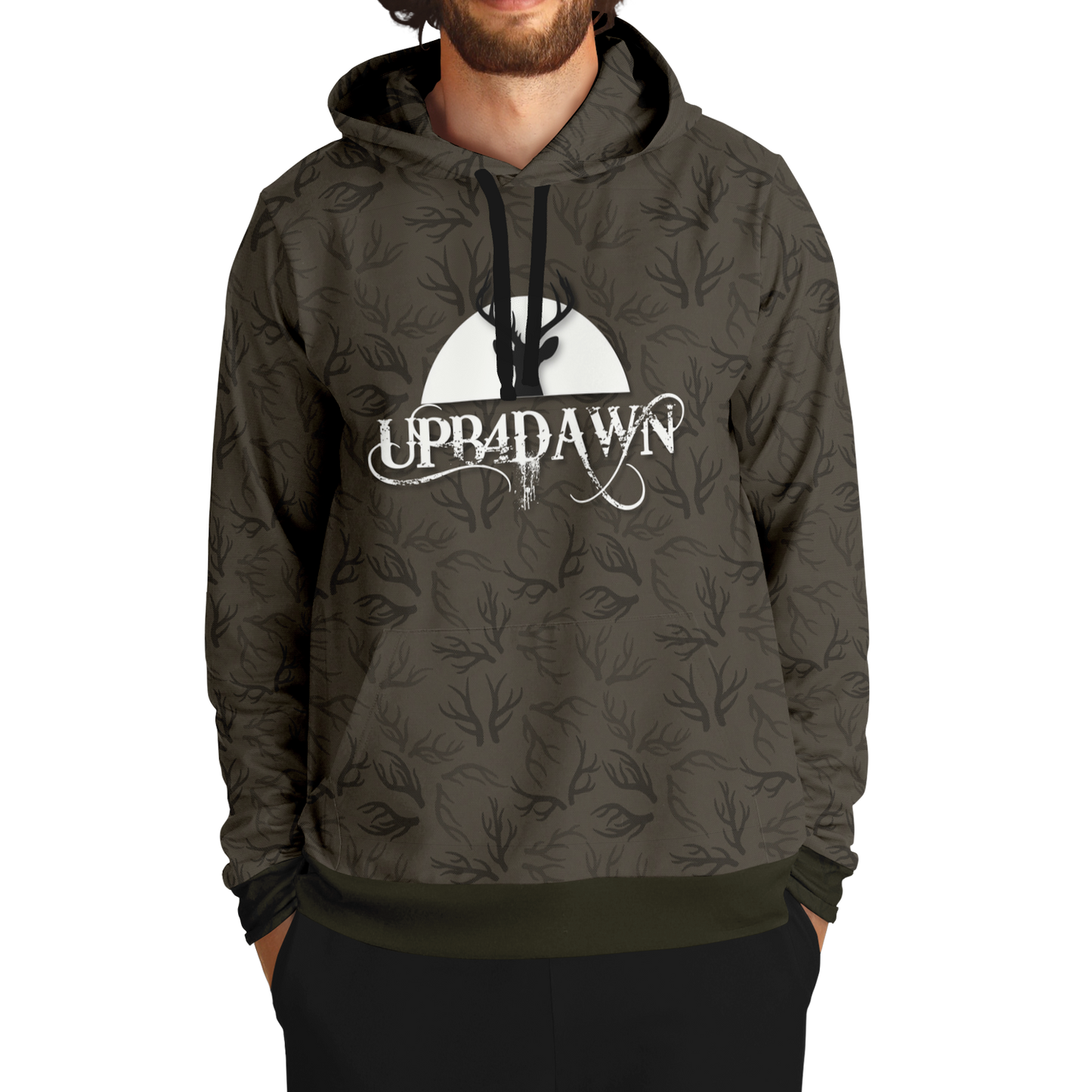 A stylish Wilderness Deer Hunter - Antler Whisper - Tri-Blend Hoodie - Bark Brown with a camouflage pattern featuring a graphic of a deer and trees under a moon, along with the text "up&dawn" printed across the front.