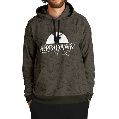 A stylish Wilderness Deer Hunter - Antler Whisper - Tri-Blend Hoodie - Bark Brown with a camouflage pattern featuring a graphic of a deer and trees under a moon, along with the text "up&dawn" printed across the front.