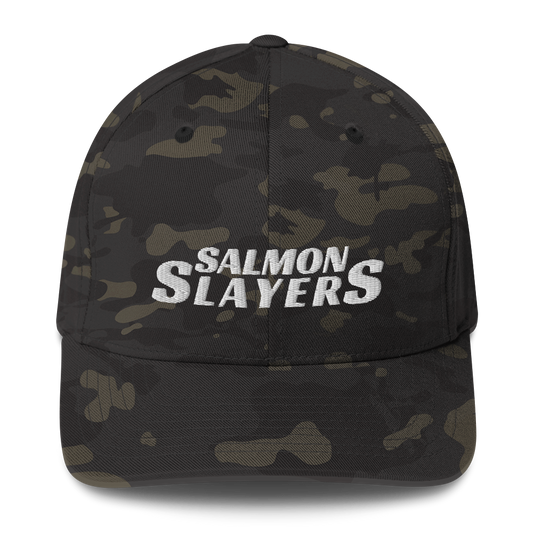 A structured camouflage baseball cap with the text "Salmon Slayers - Flex Fit" in bold, white letters across the front.