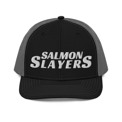 A black and gray mesh Salmon Slayers - Richardson 112 - trucker cap with the words "salmon slayers" embroidered in bold, white letters across the front.