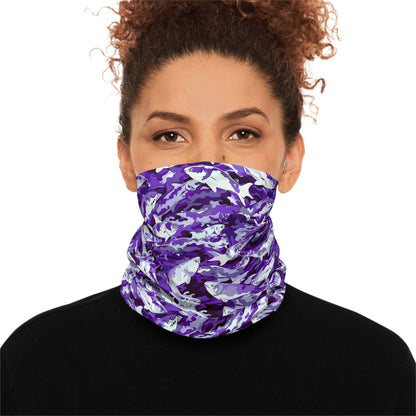 A woman with curly hair wears a Salmon Slayer - Lightweight Neck Gaiter in a fish camo pattern covering her neck and lower face. She is dressed in a black top and looks directly at the