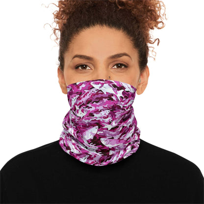 A woman with curly hair wears a Salmon Slayer - Lightweight Neck Gaiter in a fish camo pattern covering her neck and lower face. She is dressed in a black top and looks directly at the