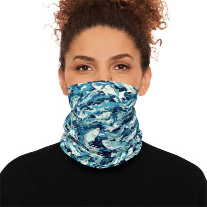 A woman with curly hair wears a Salmon Slayer - Lightweight Neck Gaiter in a fish camo pattern covering her neck and lower face. She is dressed in a black top and looks directly at the